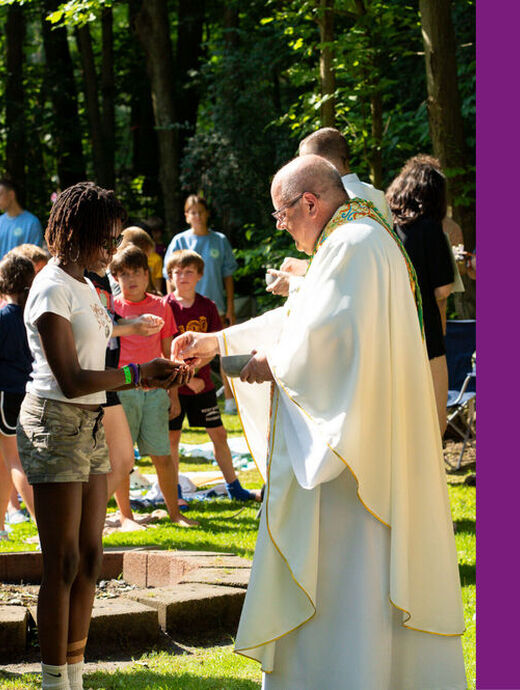Bishop Malesic with Eucharist at Camp Christopher